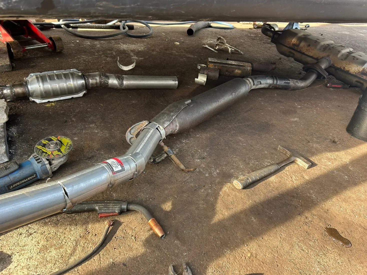 Exhaust components photographed during vehicle repair work